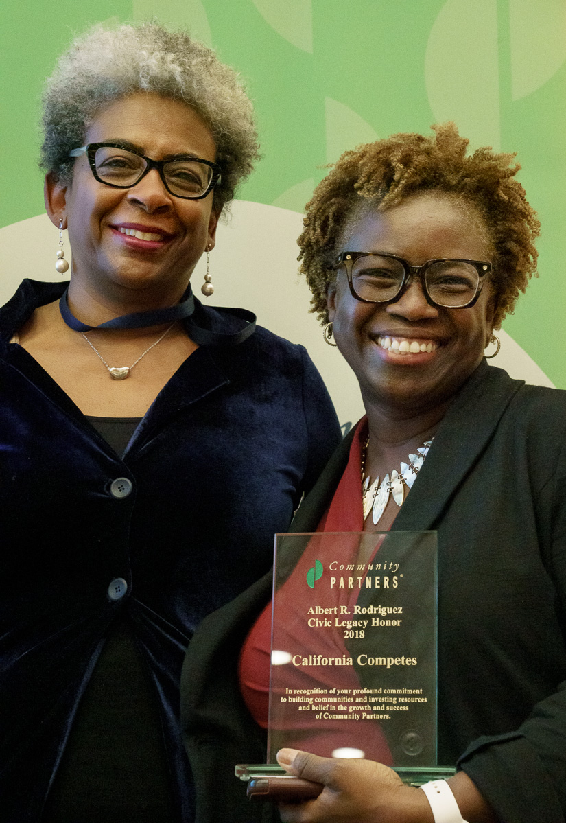 Phyllis Owens, Senior Program Director embraces California Competes' Executive Director Lande Ajose after her Al Rodriguez Honor ceremony