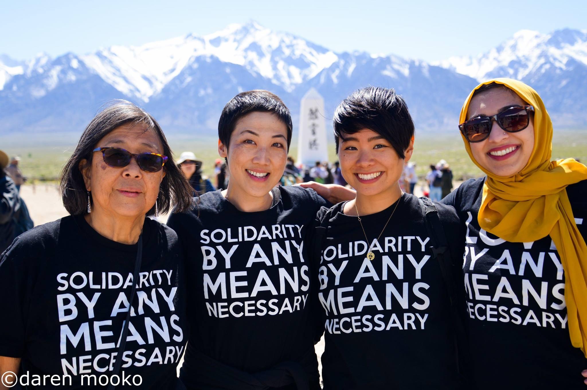 Photo of three women in front of snowy mountains